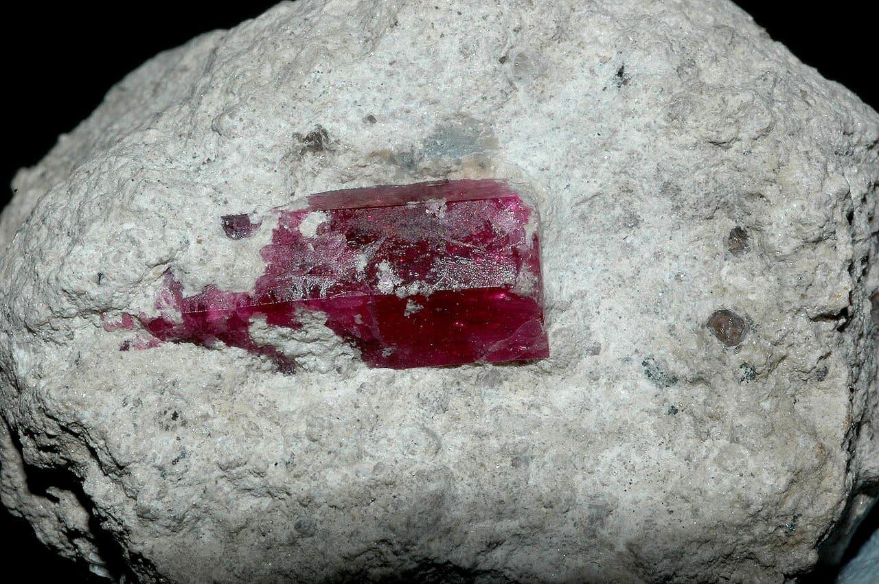 Red beryl crystal (15 mm) in rhyolite; Wah Wah Mountains, Utah