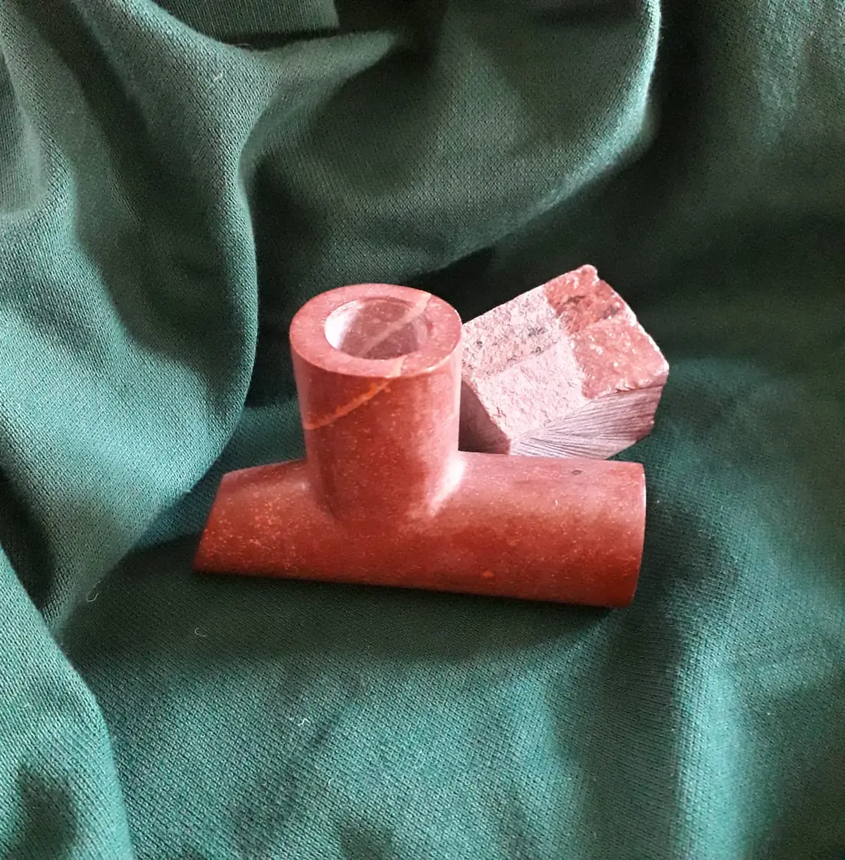 A piece of catlinite from the Pipestone quarry and a pipe carved from it