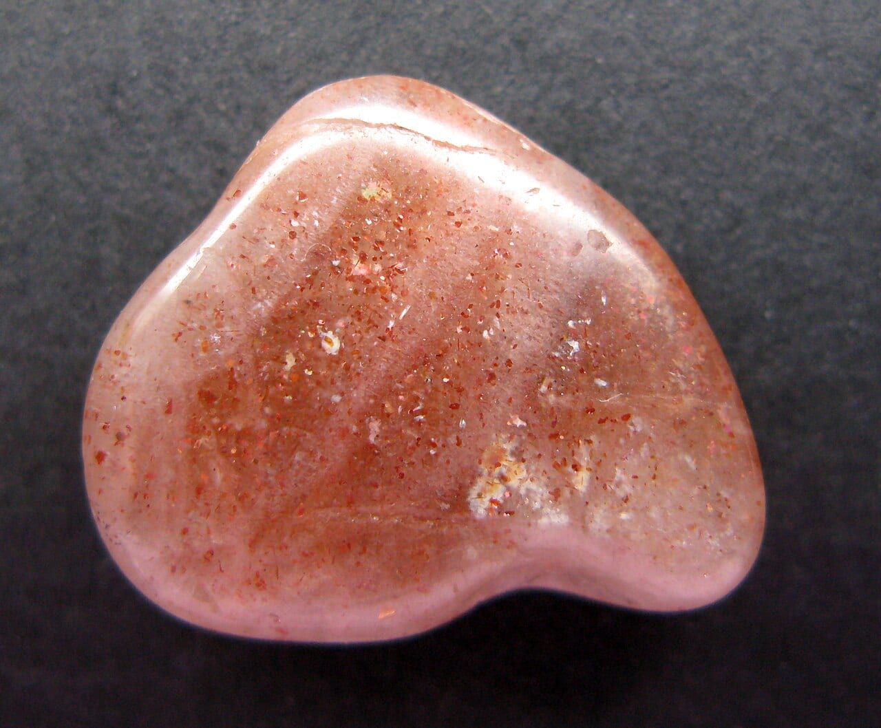 Oligoclase sunstone from India: tiny metallic platelets inside reflect light as glitter