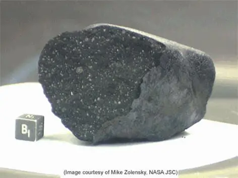 A dark piece of the Tagish Lake meteorite, looking like a charcoal briquette